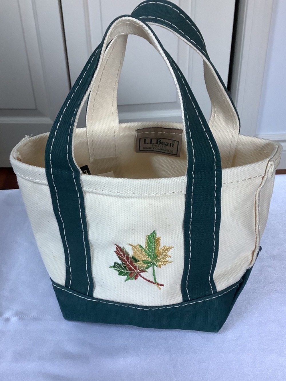 L.L. Bean Cream Canvas Micro Mini Tote with Dark Green Trim and Leaf Embroidery.